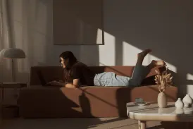 Woman on a sofa using a laptop